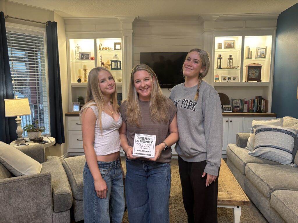 Sarah VanHoose with her daughters Harper and Jordan holding the Teens & Money guide